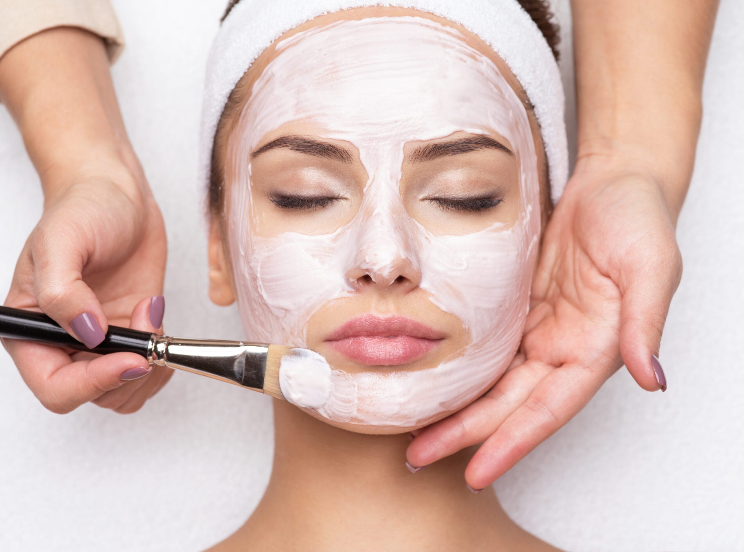 Woman receiving facial mask at beauty salon Woman receiving facial mask at beauty salon